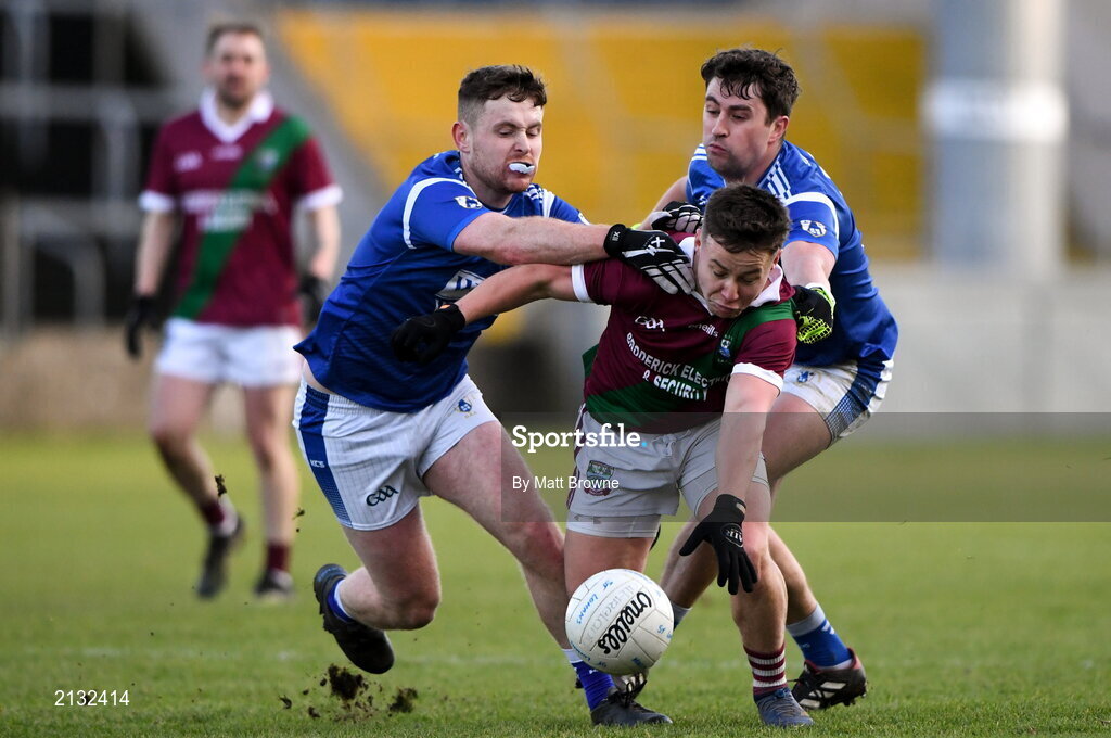 5 December 2021; Jake Foster of Portarlington in action against Oisin Hogan and Kelvin Reilly of St Loman's during the AIB Leinster GAA Football Senior Club Championship Quarter-Final match between Portarlington and St Loman's at MW Hire O’Moore Park in Portlaoise, Laois. Photo by Matt Browne/Sportsfile
