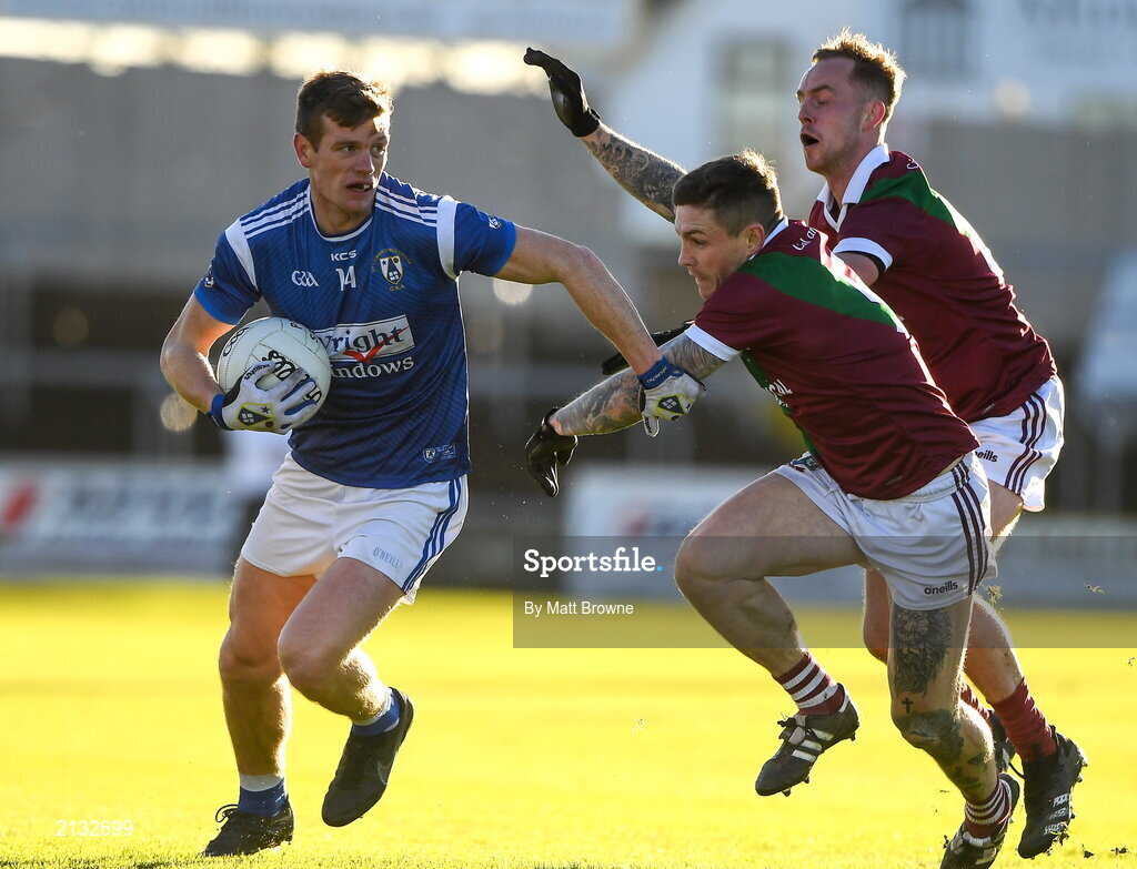5 December 2021; John Heslin of St Loman's in action against Stuart Mulpeter and Adam Ryan of Portarlington during the AIB Leinster GAA Football Senior Club Championship Quarter-Final match between Portarlington and St Loman's at MW Hire O’Moore Park in Portlaoise, Laois. Photo by Matt Browne/Sportsfile