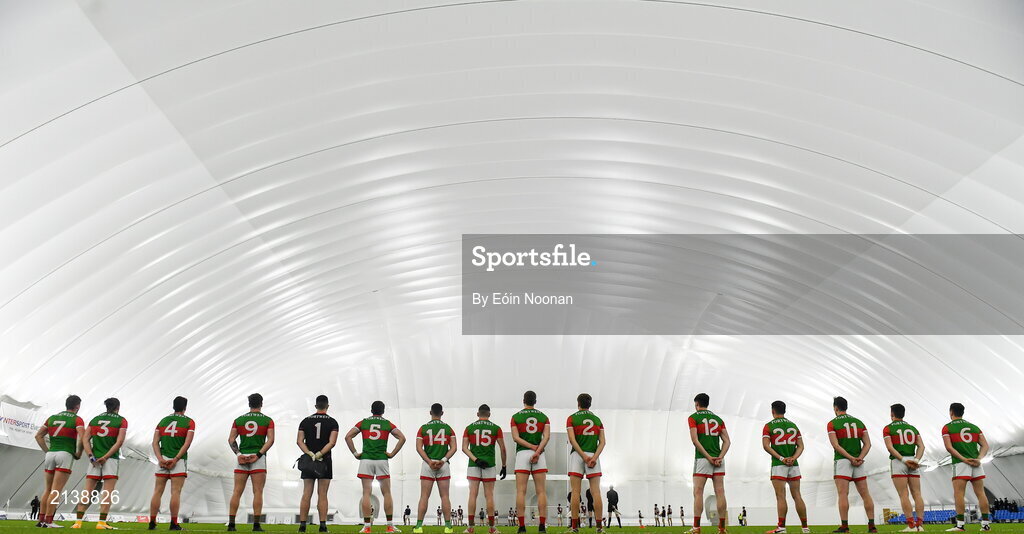 7 January 2022; Mayo players stand for the playing of Amhrán na bhFiann before the Connacht FBD League semi-final match between Mayo and Galway at the NUI Galway Connacht GAA Air Dome in Bekan, Mayo. Photo by Eóin Noonan/Sportsfile