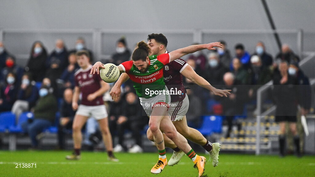 7 January 2022; Padraig O’Hora of Mayo is tackled by Damien Comer of Galway during the Connacht FBD League semi-final match between Mayo and Galway at the NUI Galway Connacht GAA Air Dome in Bekan, Mayo. Photo by Eóin Noonan/Sportsfile