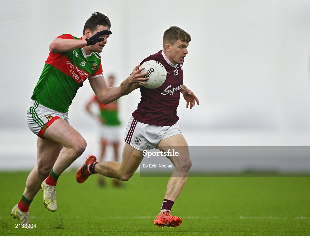 7 January 2022; Liam Costello of Galway in action against Matthew Ruane of Mayo during the Connacht FBD League semi-final match between Mayo and Galway at the NUI Galway Connacht GAA Air Dome in Bekan, Mayo. Photo by Eóin Noonan/Sportsfile