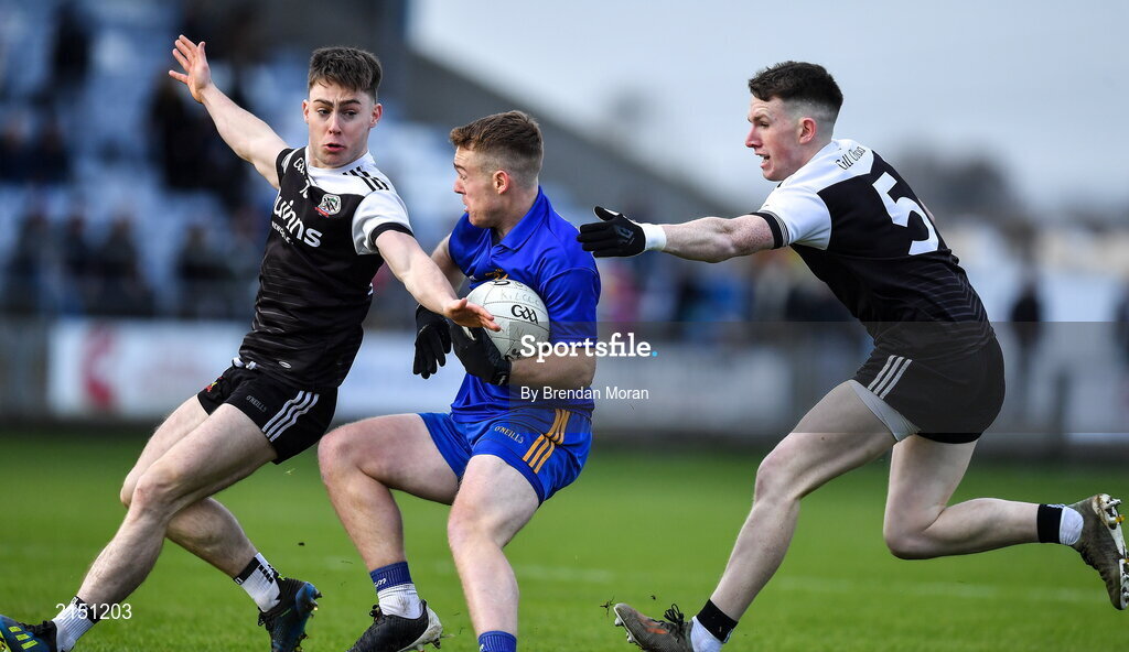 29 January 2022; Eoin McGreevey of St Finbarr's in action against Ceilum Docherty, left, and Miceal Rooney of Kilcoo during the AIB GAA Football All-Ireland Senior Club Championship Semi-Final match between St Finbarr's, Cork, and Kilcoo, Down, at MW Hire O'Moore Park in Portlaoise, Laois. Photo by Brendan Moran/Sportsfile
