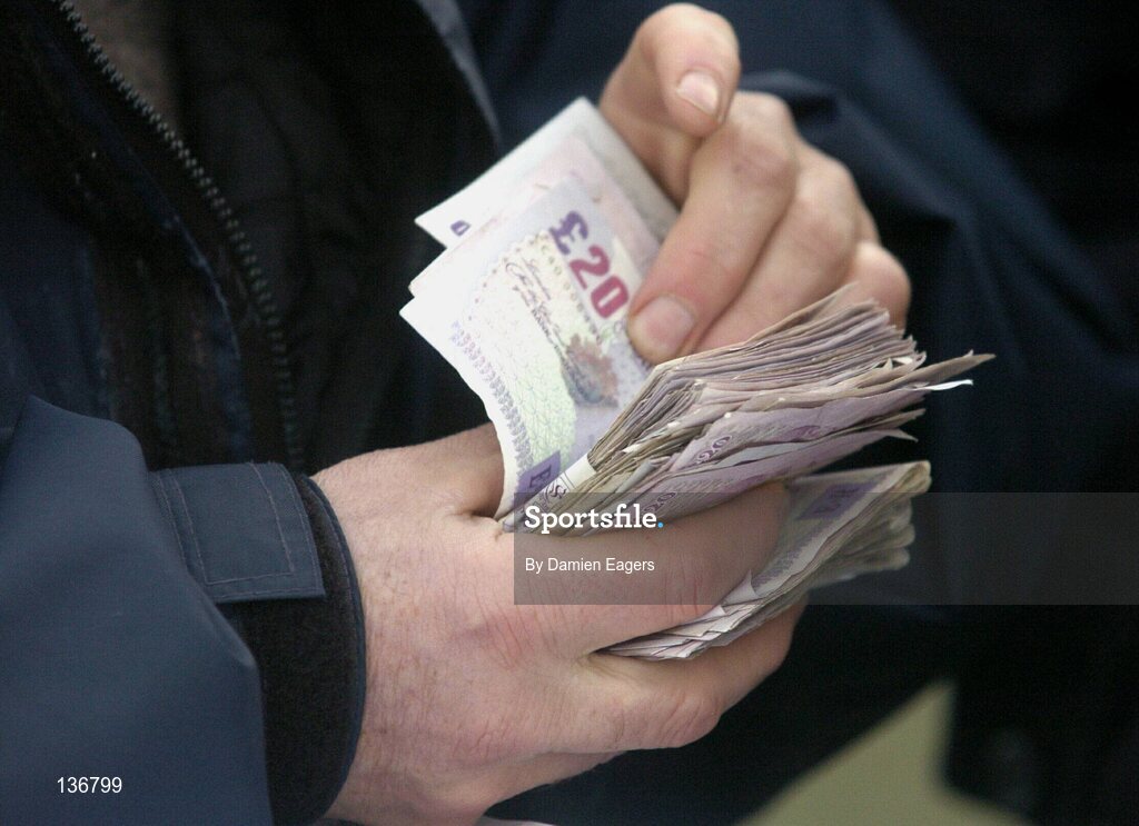 18 March 2004; A racegoer counts his winnings after the Vincent O'Brien County Handicap Hurdle Race, Cheltenham Festival, Prestbury Park, Cheltenham, England. Horse Racing. Picture credit; Damien Eagers / SPORTSFILE *EDI*