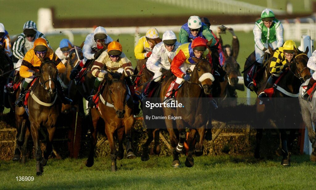 16 March 2004; Runners and Riders clear the last 'first time around' during the Pertemps Final Handicap Hurdle, Cheltenham Festival, Prestbury Park, Cheltenham, England. Horse Racing. Picture credit; Damien Eagers / SPORTSFILE *EDI*