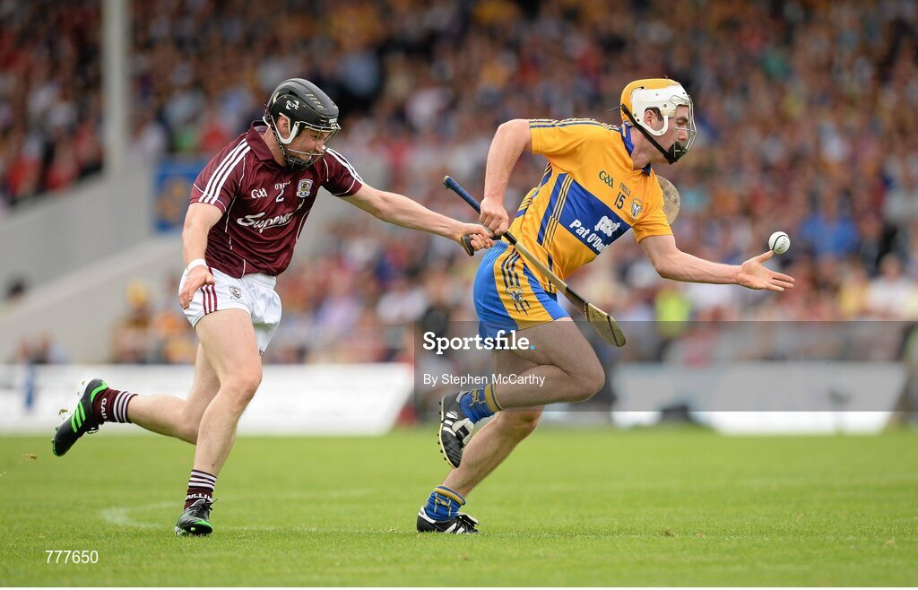 28 July 2013; Conor McGrath, Clare, on his way to scoring his side's first goal despite the efforts of Kevin Hynes, Galway. GAA Hurling All-Ireland Senior Championship, Quarter-Final, Galway v Clare, Semple Stadium, Thurles, Co. Tipperary. Picture credit: Stephen McCarthy / SPORTSFILE