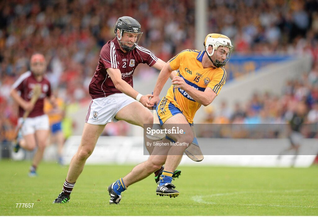 28 July 2013; Conor McGrath, Clare, on his way to scoring his side's first goal despite the efforts of Kevin Hynes, Galway. GAA Hurling All-Ireland Senior Championship, Quarter-Final, Galway v Clare, Semple Stadium, Thurles, Co. Tipperary. Picture credit: Stephen McCarthy / SPORTSFILE