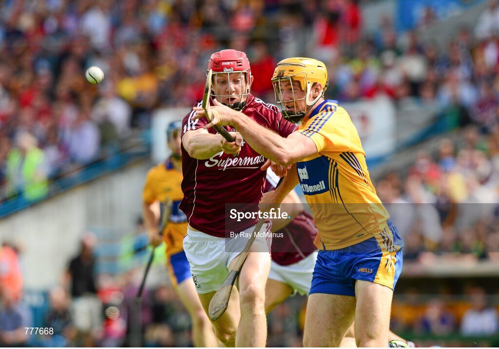 28 July 2013; Cian Dillon, Clare, clears under pressure from Galway's Joe Canning. GAA Hurling All-Ireland Senior Championship, Quarter-Final, Galway v Clare, Semple Stadium, Thurles, Co. Tipperary. Picture credit: Ray McManus / SPORTSFILE