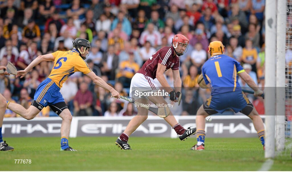 28 July 2013; Jonathan Glynn, Galway, shoots to score his side's first goal past Clare goalkeeper Patrick Kelly and Patrick Donnellan, left. GAA Hurling All-Ireland Senior Championship, Quarter-Final, Galway v Clare, Semple Stadium, Thurles, Co. Tipperary. Picture credit: Stephen McCarthy / SPORTSFILE