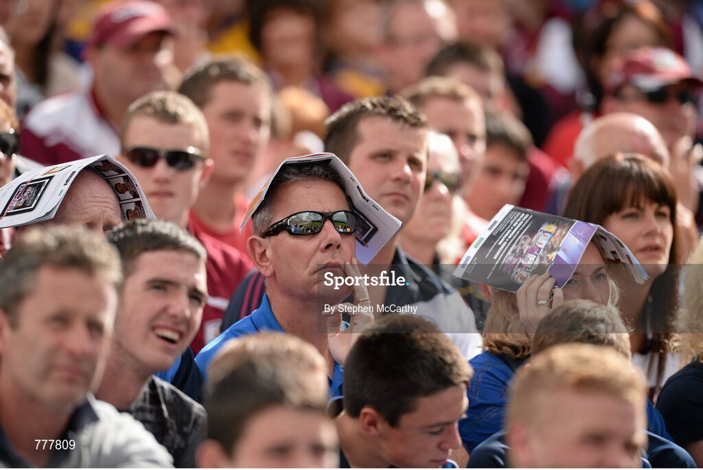 28 July 2013; Supporters use programmes to shiled from the sun. GAA Hurling All-Ireland Senior Championship, Quarter-Final, Galway v Clare, Semple Stadium, Thurles, Co. Tipperary. Picture credit: Stephen McCarthy / SPORTSFILE