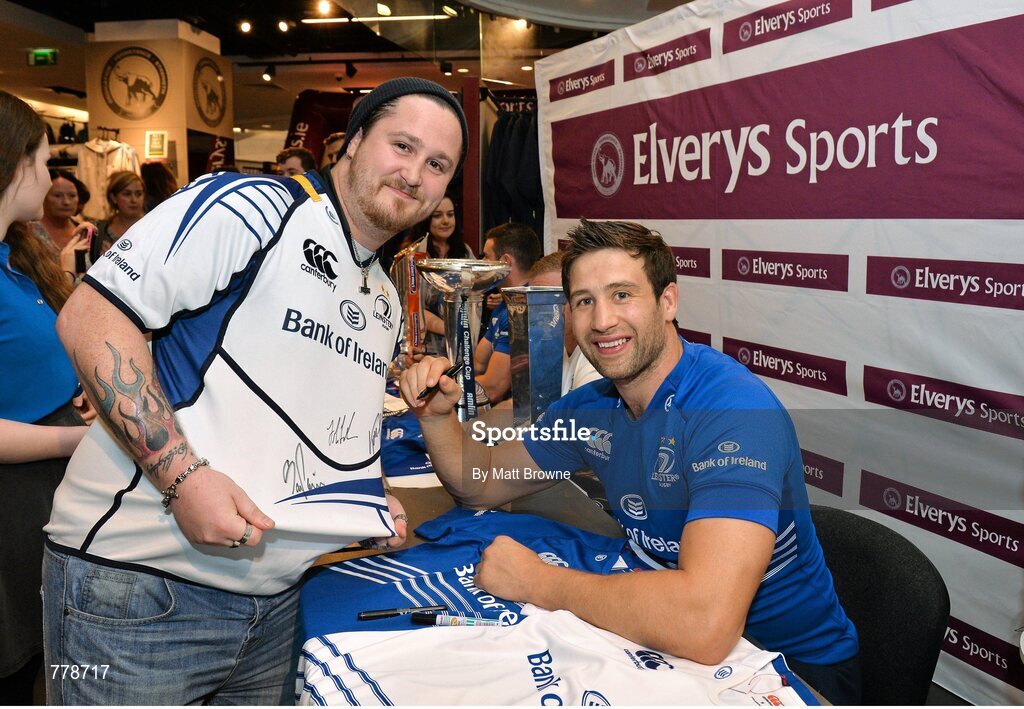 1 August 2013: Leinster's Kevin McLaughlin with CJ Sykes, from Ballyfermot, Dublin, at Canterbury's launch of the new Leinster 2013/14 jersey, hosted by Elverys Sports in Arnotts. Leinster will wear the new jersey in match action for the first time at home on Friday 30th August, when they come up against Northampton Saints in a friendly at the Donnybrook Stadium. Elverys Sports, Arnotts, Dublin. Picture credit: Matt Browne / SPORTSFILE