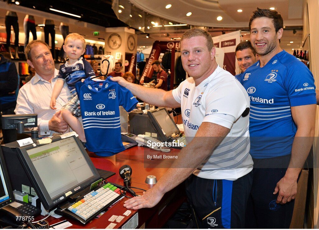 1 August 2013: Leinster supporter Ciaran O'Flynn, aged 4, from Ranelagh, Dublin, gets his new Leinster jersey from Leinster players Sean Cronin, Fergus McFadden and Kevin McLaughlin at Canterbury's launch of the new Leinster 2013/14 jersey, hosted by Elverys Sports in Arnotts. Leinster will wear the new jersey in match action for the first time at home on Friday 30th August, when they come up against Northampton Saints in a friendly at the Donnybrook Stadium. Elverys Sports, Arnotts, Dublin. Picture credit: Matt Browne / SPORTSFILE