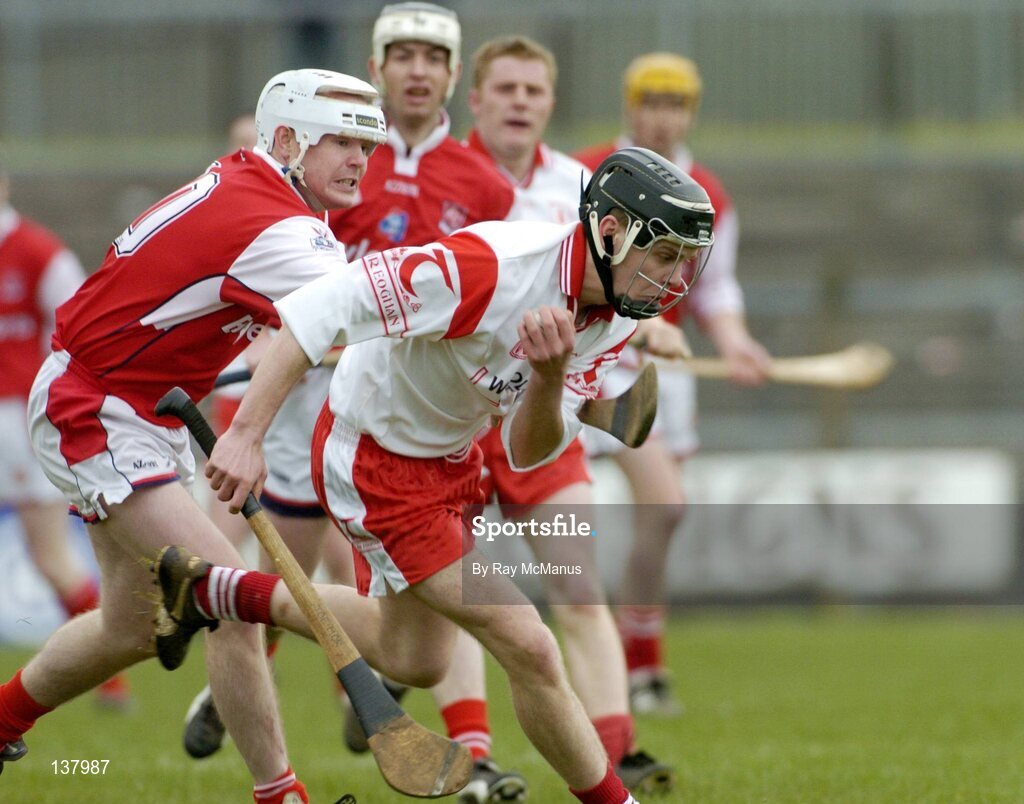 28 March 2004; Joseph O'Neill, Tyrone, in action against Louth's Ger Collins. Allianz National Hurling League Division 3B, Round 5, Tyrone v Louth, Healy Park, Omagh, Co. Tyrone. Picture credit; Ray McManus / SPORTSFILE *EDI*