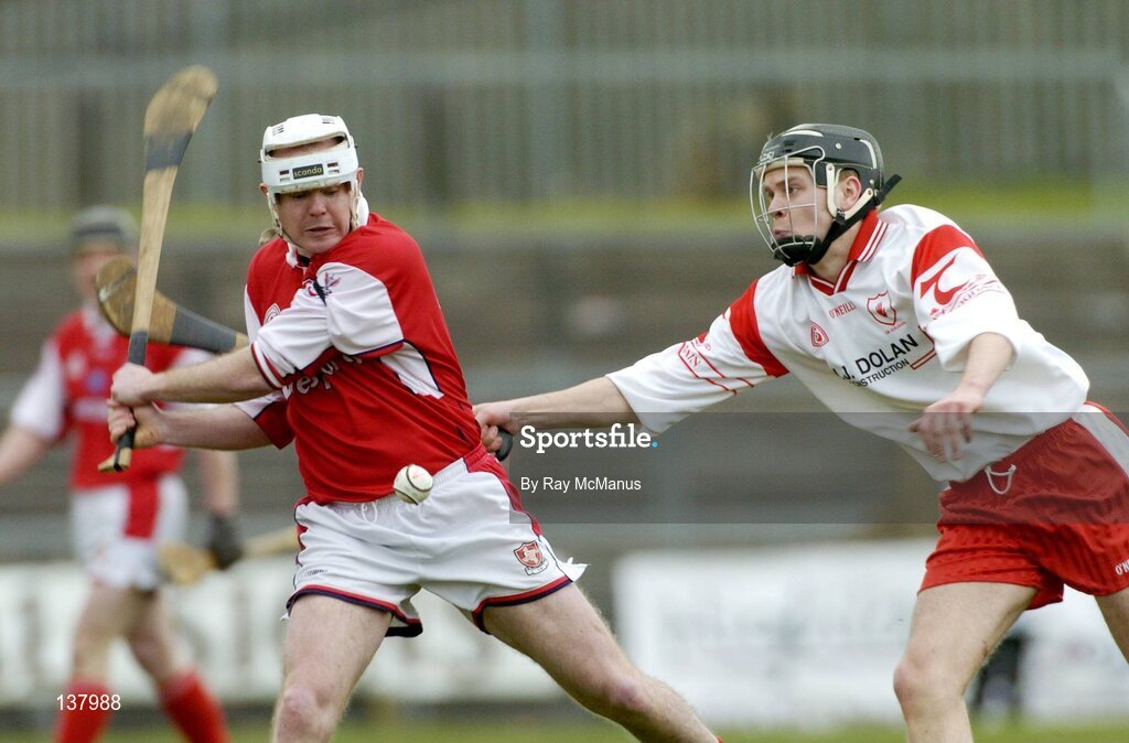 28 March 2004; Ger Collins, Louth, in action against Tyrone's Joseph O'Neill. Allianz National Hurling League Division 3B, Round 5, Tyrone v Louth, Healy Park, Omagh, Co. Tyrone. Picture credit; Ray McManus / SPORTSFILE *EDI*