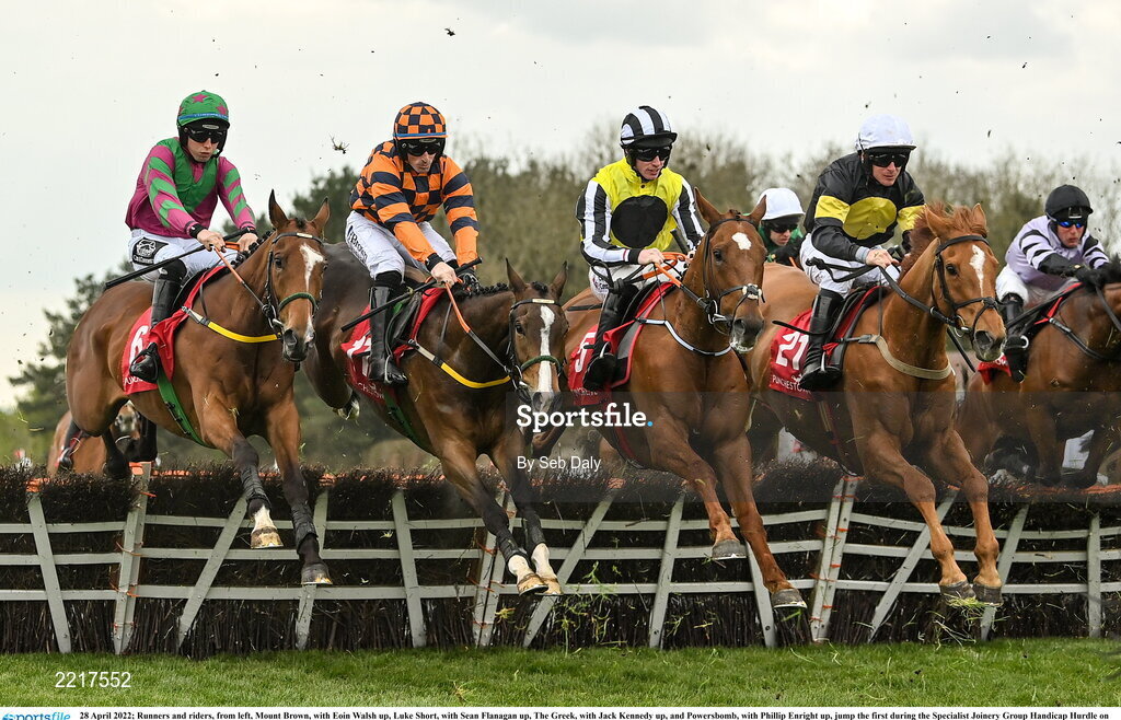 28 April 2022; Runners and riders, from left, Mount Brown, with Eoin Walsh up, Luke Short, with Sean Flanagan up, The Greek, with Jack Kennedy up, and Powersbomb, with Phillip Enright up, jump the first during the Specialist Joinery Group Handicap Hurdle on day three of the Punchestown Festival at Punchestown Racecourse in Kildare. Photo by Seb Daly/Sportsfile