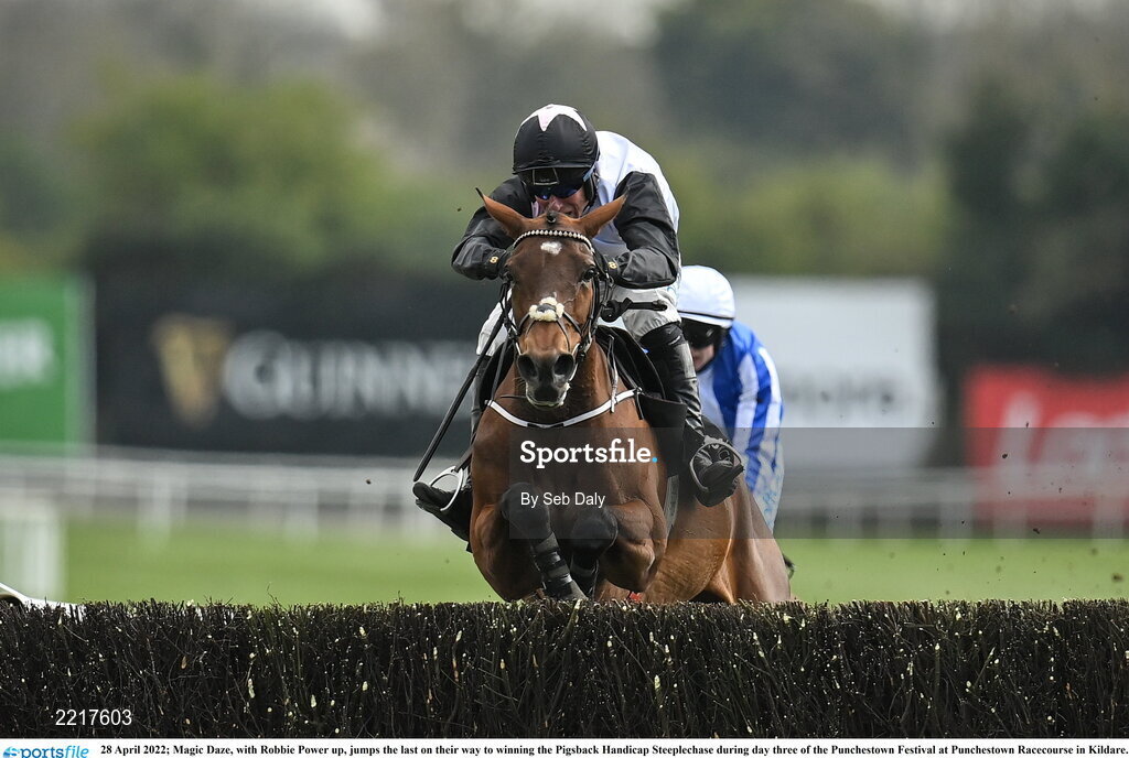 28 April 2022; Magic Daze, with Robbie Power up, jumps the last on their way to winning the Pigsback Handicap Steeplechase during day three of the Punchestown Festival at Punchestown Racecourse in Kildare. Photo by Seb Daly/Sportsfile