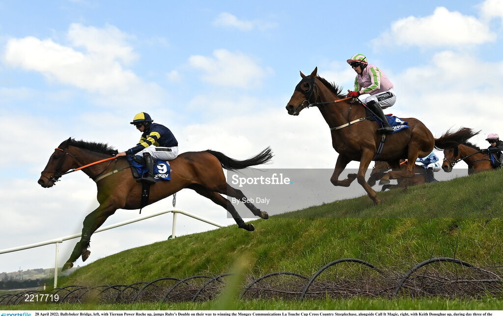28 April 2022; Ballyboker Bridge, left, with Tiernan Power Roche up, jumps Ruby's Double on their way to winning the Mongey Communications La Touche Cup Cross Country Steeplechase, alongside Call It Magic, right, with Keith Donoghue up, during day three of the Punchestown Festival at Punchestown Racecourse in Kildare. Photo by Seb Daly/Sportsfile