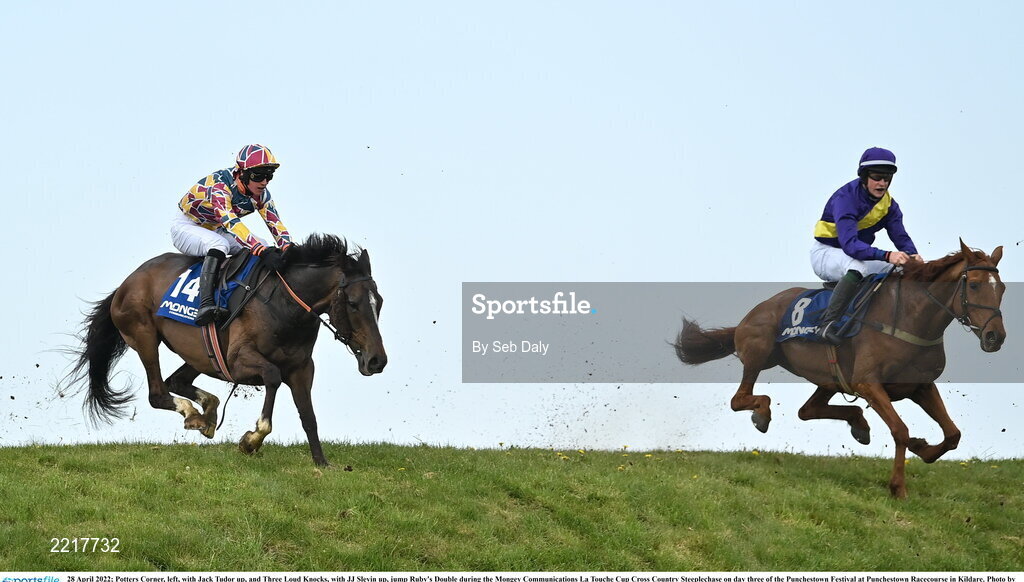 28 April 2022; Potters Corner, left, with Jack Tudor up, and Three Loud Knocks, with JJ Slevin up, jump Ruby's Double during the Mongey Communications La Touche Cup Cross Country Steeplechase on day three of the Punchestown Festival at Punchestown Racecourse in Kildare. Photo by Seb Daly/Sportsfile