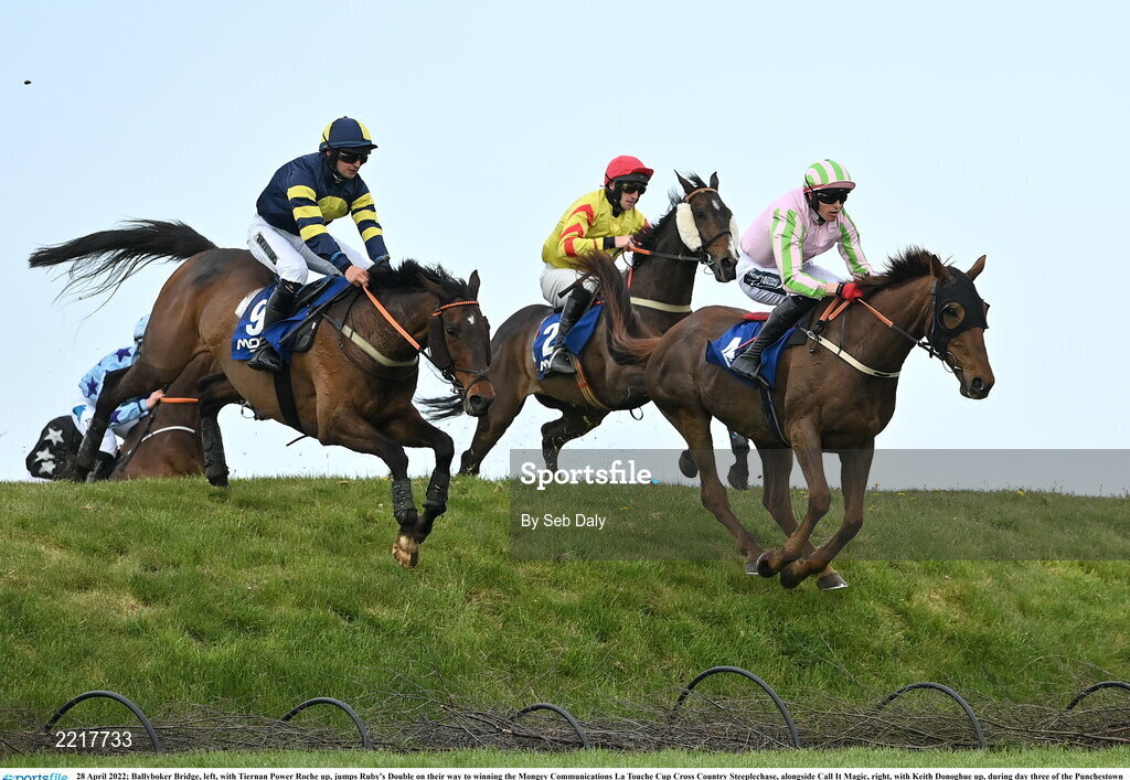 28 April 2022; Ballyboker Bridge, left, with Tiernan Power Roche up, jumps Ruby's Double on their way to winning the Mongey Communications La Touche Cup Cross Country Steeplechase, alongside Call It Magic, right, with Keith Donoghue up, during day three of the Punchestown Festival at Punchestown Racecourse in Kildare. Photo by Seb Daly/Sportsfile