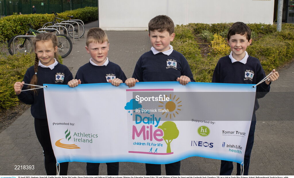 29 April 2022; Students, from left, Emilia Spyrka, Dylan McCarthy, Oscar Paskevicius and Odhran O’Sullivan welcome Minister for Education Norma Foley TD and Minister of State for Sport and the Gaeltacht Jack Chambers TD, on a visit to Nagle Rice Primary School, Ballyoughtragh North in Kerry, while visiting local schools to support children taking part in ‘the Daily Mile'. Photo by Domnick Walsh/Sportsfile