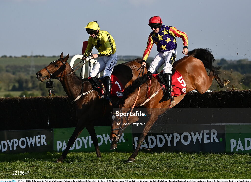 29 April 2022; Billaway, with Patrick Mullins up, left, jumps the last alongside Vaucelet, with Barry O'Neill, who almost fell, on their way to winning the Irish Daily Star Champion Hunters Steeplechase during day four of the Punchestown Festival at Punchestown Racecourse in Kildare. Photo by David Fitzgerald/Sportsfile