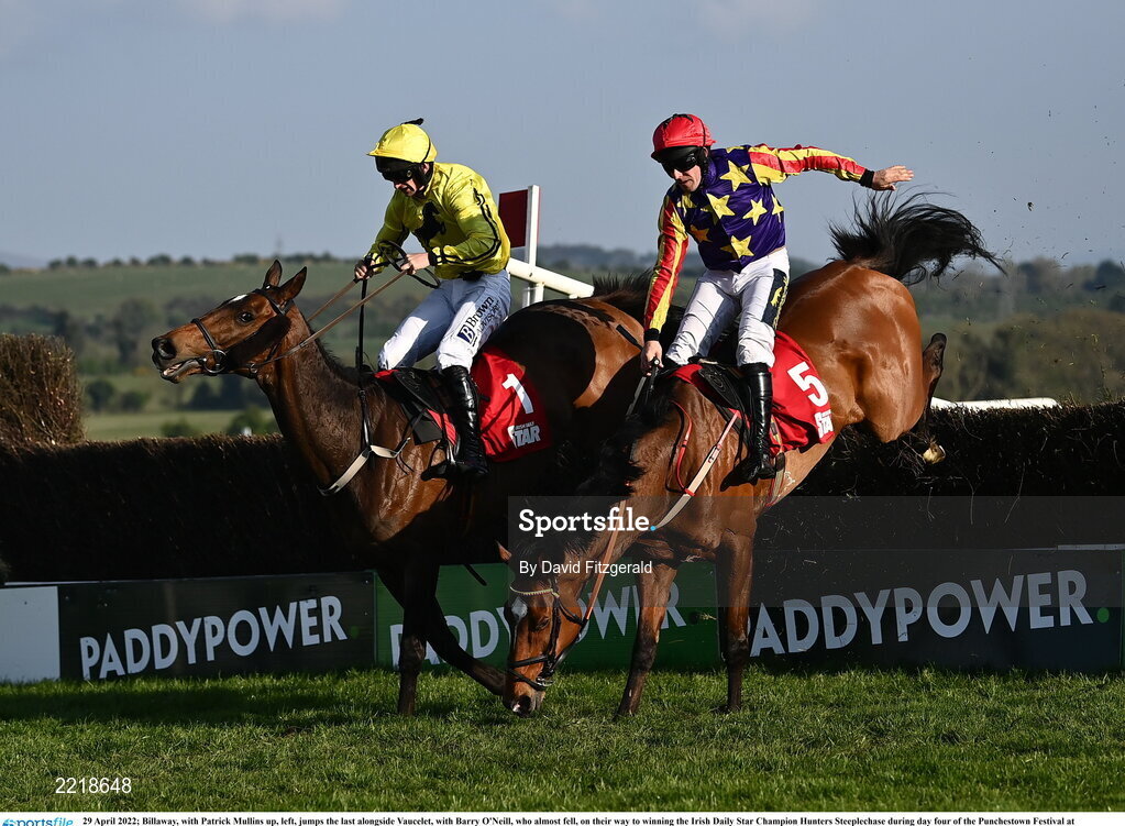 29 April 2022; Billaway, with Patrick Mullins up, left, jumps the last alongside Vaucelet, with Barry O'Neill, who almost fell, on their way to winning the Irish Daily Star Champion Hunters Steeplechase during day four of the Punchestown Festival at Punchestown Racecourse in Kildare. Photo by David Fitzgerald/Sportsfile