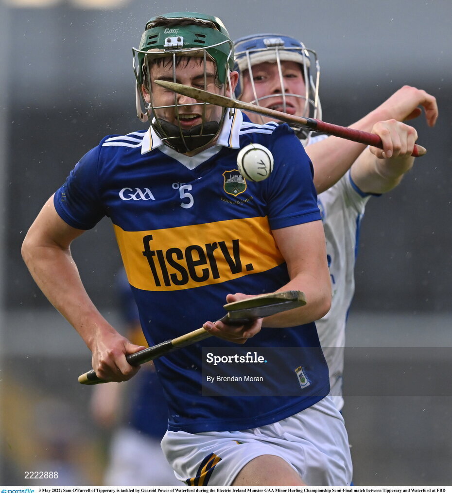 3 May 2022; Sam O'Farrell of Tipperary is tackled by Gearoid Power of Waterford during the Electric Ireland Munster GAA Minor Hurling Championship Semi-Final match between Tipperary and Waterford at FBD Semple Stadium in Thurles, Tipperary. Photo by Brendan Moran/Sportsfile