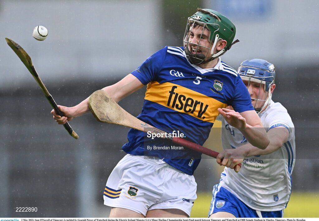 3 May 2022; Sam O'Farrell of Tipperary is tackled by Gearoid Power of Waterford during the Electric Ireland Munster GAA Minor Hurling Championship Semi-Final match between Tipperary and Waterford at FBD Semple Stadium in Thurles, Tipperary. Photo by Brendan Moran/Sportsfile