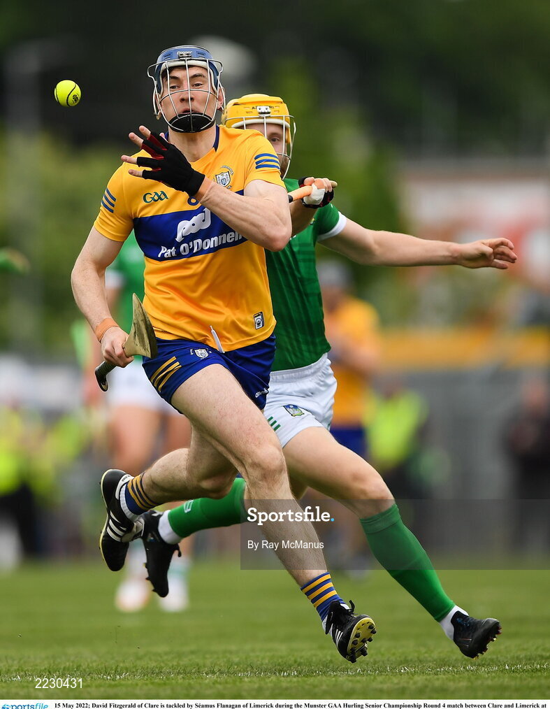 15 May 2022; David Fitzgerald of Clare is tackled by Séamus Flanagan of Limerick during the Munster GAA Hurling Senior Championship Round 4 match between Clare and Limerick at Cusack Park in Ennis, Clare. Photo by Ray McManus/Sportsfile
