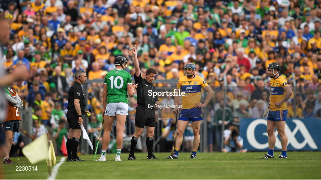15 May 2022; Referee Colm Lyons shows a yellow catrd to Gearóid Hegarty of Limerick, 10, during the Munster GAA Hurling Senior Championship Round 4 match between Clare and Limerick at Cusack Park in Ennis, Clare. Photo by Ray McManus/Sportsfile