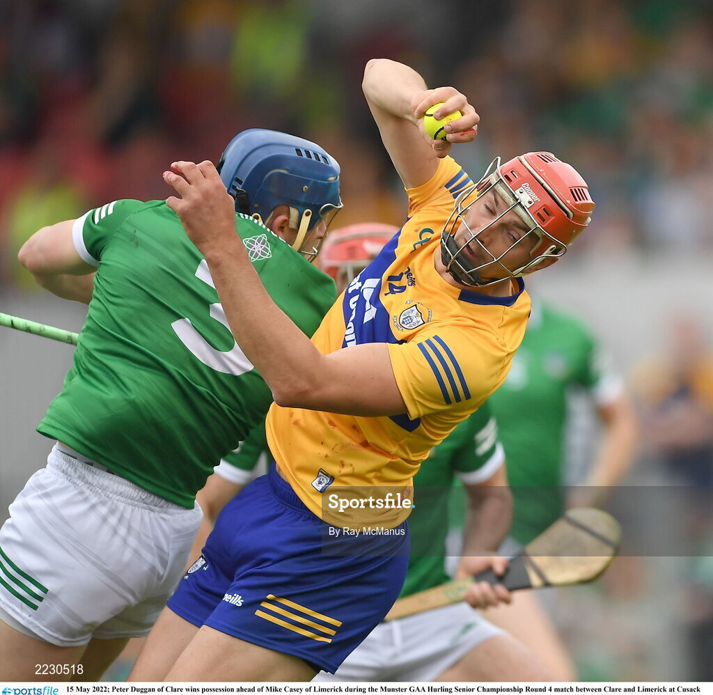 15 May 2022; Peter Duggan of Clare wins possession ahead of Mike Casey of Limerick during the Munster GAA Hurling Senior Championship Round 4 match between Clare and Limerick at Cusack Park in Ennis, Clare. Photo by Ray McManus/Sportsfile