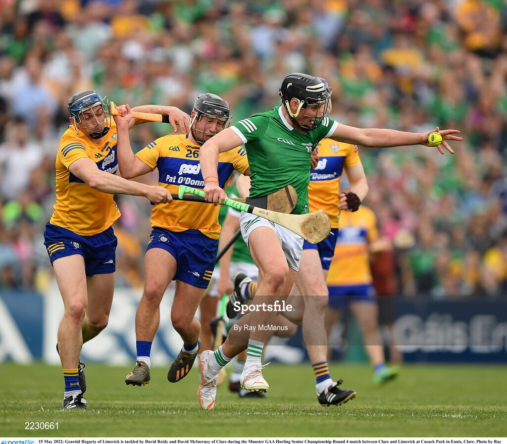 15 May 2022; Gearóid Hegarty of Limerick is tackled by David Reidy and David McInerney of Clare during the Munster GAA Hurling Senior Championship Round 4 match between Clare and Limerick at Cusack Park in Ennis, Clare. Photo by Ray McManus/Sportsfile