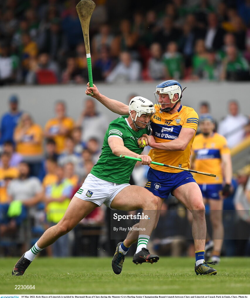 15 May 2022; Kyle Hayes of Limerick is tackled by Diarmuid Ryan of Clare during the Munster GAA Hurling Senior Championship Round 4 match between Clare and Limerick at Cusack Park in Ennis, Clare. Photo by Ray McManus/Sportsfile