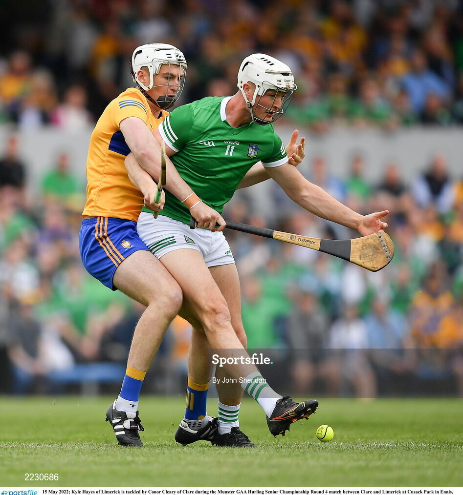 15 May 2022; Kyle Hayes of Limerick is tackled by Conor Cleary of Clare during the Munster GAA Hurling Senior Championship Round 4 match between Clare and Limerick at Cusack Park in Ennis, Clare. Photo by John Sheridan/Sportsfile