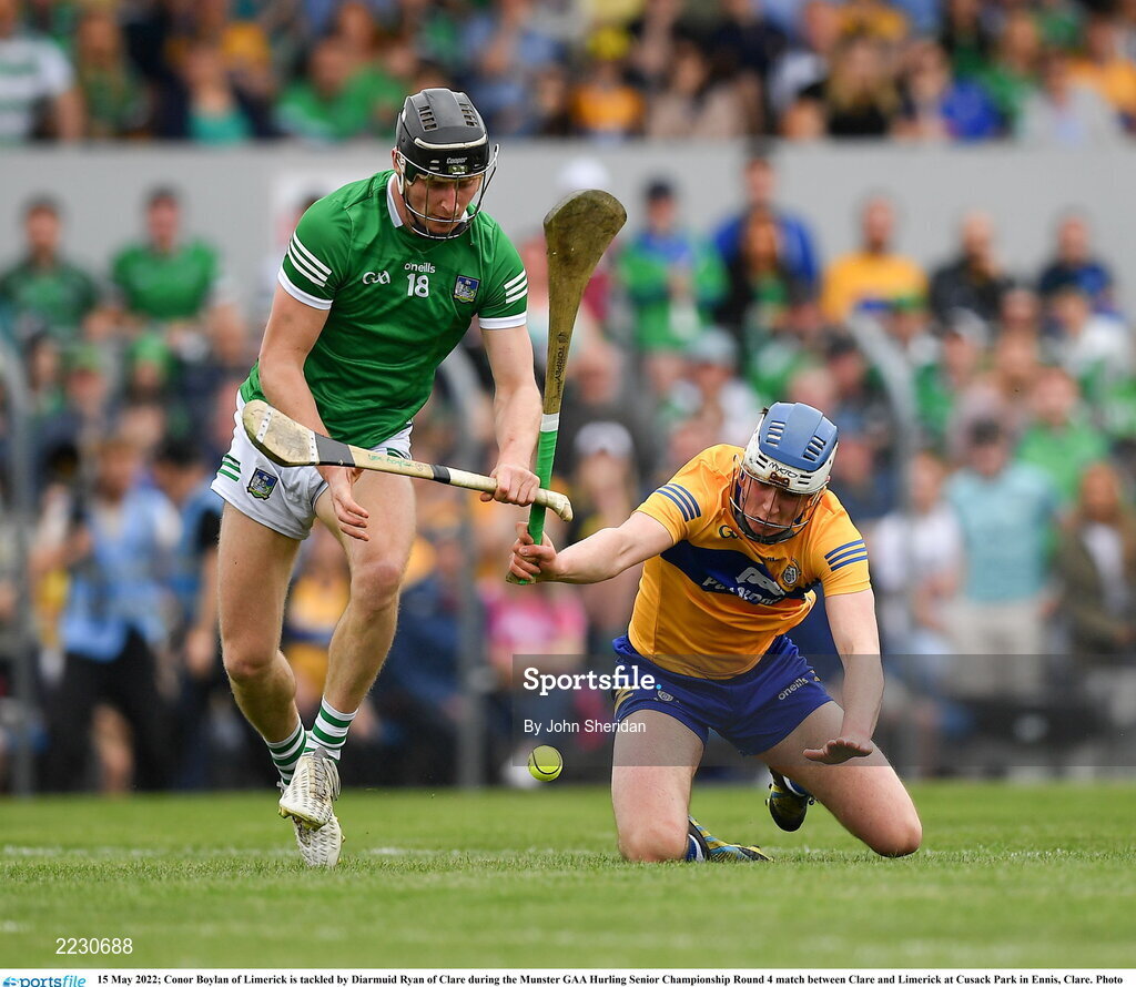 15 May 2022; Conor Boylan of Limerick is tackled by Diarmuid Ryan of Clare during the Munster GAA Hurling Senior Championship Round 4 match between Clare and Limerick at Cusack Park in Ennis, Clare. Photo by John Sheridan/Sportsfile