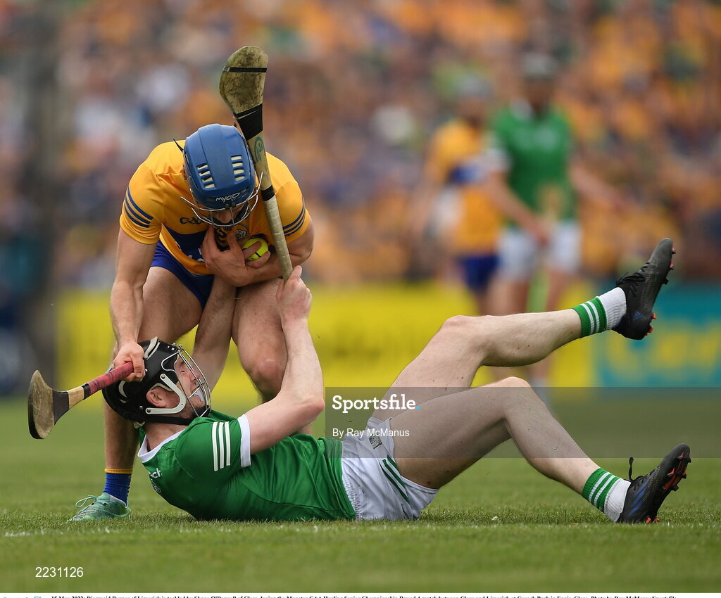 15 May 2022; Diarmaid Byrnes of Limerick is tackled by Shane O'Donnell of Clare during the Munster GAA Hurling Senior Championship Round 4 match between Clare and Limerick at Cusack Park in Ennis, Clare. Photo by Ray McManus/Sportsfile