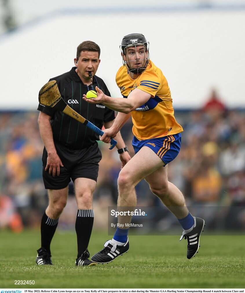 15 May 2022; Referee Colm Lyons keeps an eye as Tony Kelly of Clare prepares to takes a shot during the Munster GAA Hurling Senior Championship Round 4 match between Clare and Limerick at Cusack Park in Ennis, Clare. Photo by Ray McManus/Sportsfile