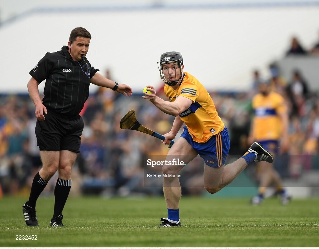 15 May 2022; Referee Colm Lyons steps out of the way as Tony Kelly of Clare prepares to takes a shot during the Munster GAA Hurling Senior Championship Round 4 match between Clare and Limerick at Cusack Park in Ennis, Clare. Photo by Ray McManus/Sportsfile