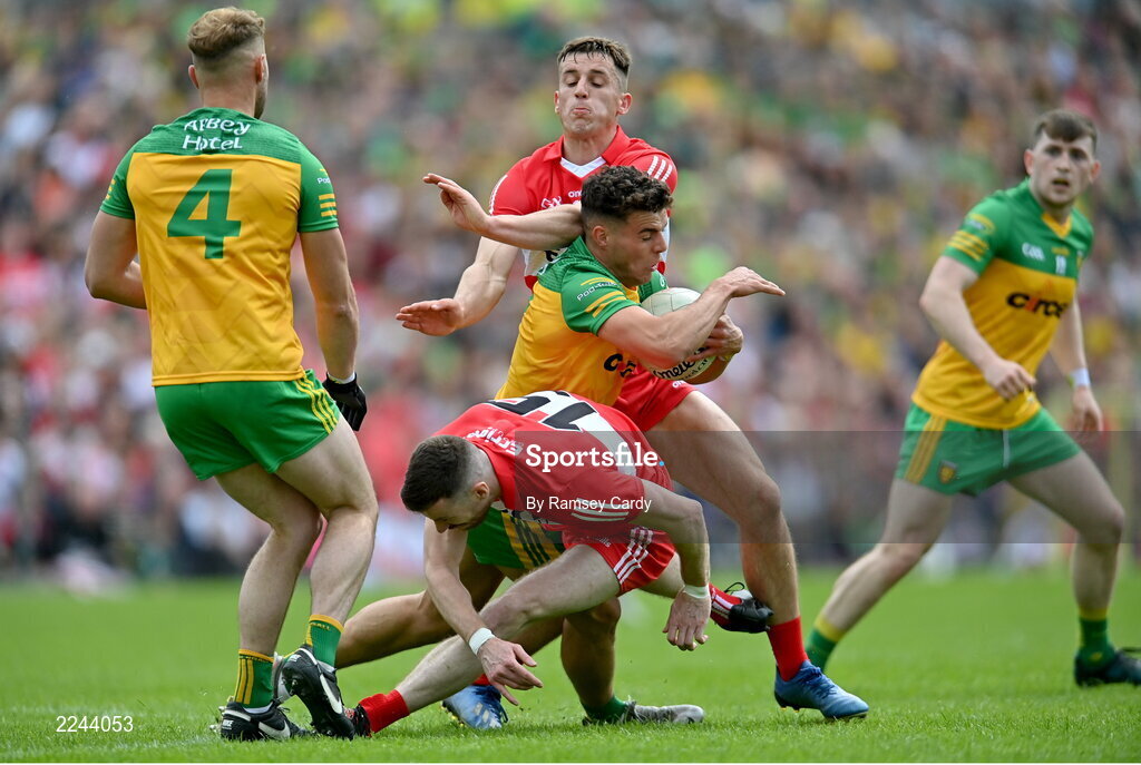 29 May 2022; Odhran McFadden Ferry of Donegal in action against Niall Loughlin, below, and Shane McGuigan of Derry during the Ulster GAA Football Senior Championship Final between Derry and Donegal at St Tiernach's Park in Clones, Monaghan. Photo by Ramsey Cardy/Sportsfile