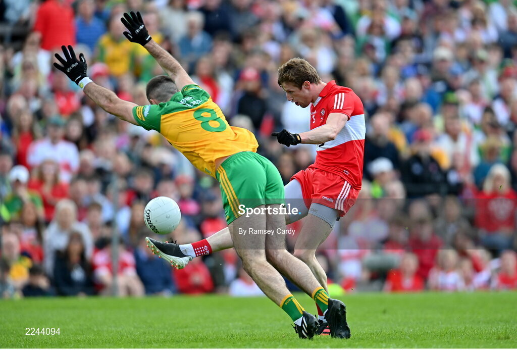 29 May 2022; Brendan Rogers of Derry kicks a first half point under pressure from Caolan McGonagle of Donegal during the Ulster GAA Football Senior Championship Final between Derry and Donegal at St Tiernach's Park in Clones, Monaghan. Photo by Ramsey Cardy/Sportsfile
