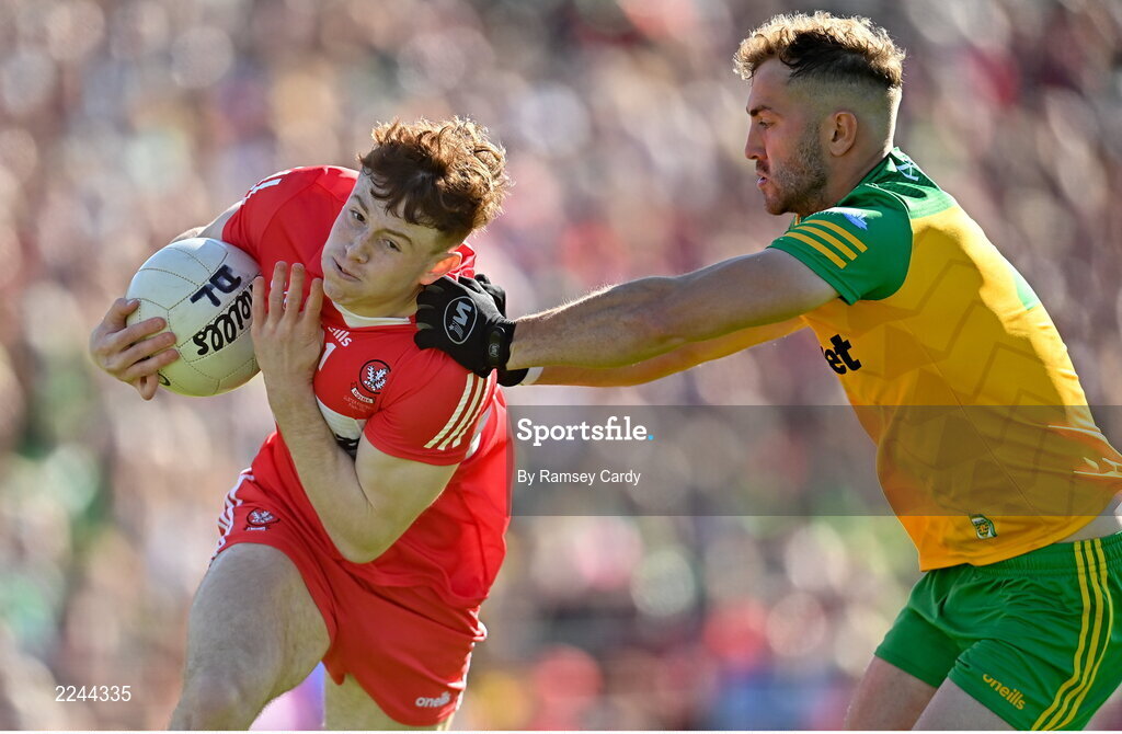 29 May 2022; Lachlan Murray of Derry is tackled by Stephen McMenamin of Donegal during the Ulster GAA Football Senior Championship Final between Derry and Donegal at St Tiernach's Park in Clones, Monaghan. Photo by Ramsey Cardy/Sportsfile