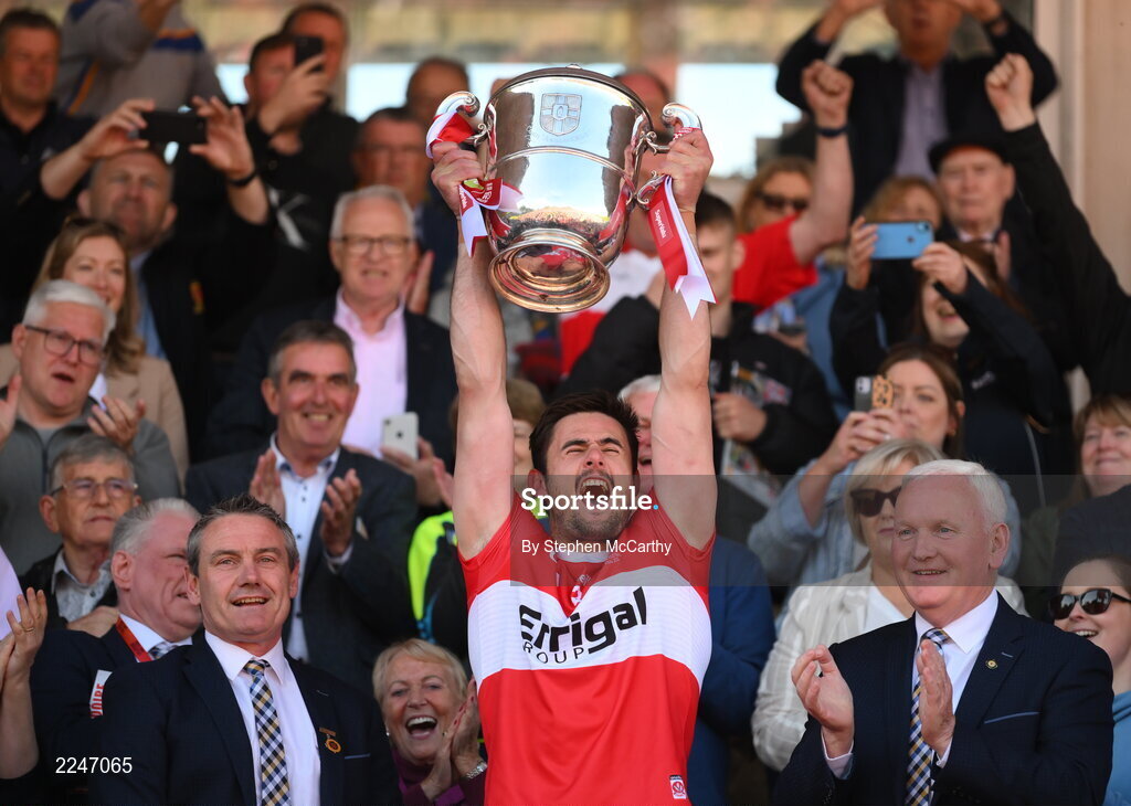 29 May 2022; Derry captain Christopher McKaigue lifts the Anglo Celt Cup alongside Ulster GAA president Ciaran McLaughlin, left, and Ulster GAA vice-president Michael Geoghegan, right, during the Ulster GAA Football Senior Championship Final between Derry and Donegal at St Tiernach's Park in Clones, Monaghan. Photo by Stephen McCarthy/Sportsfile