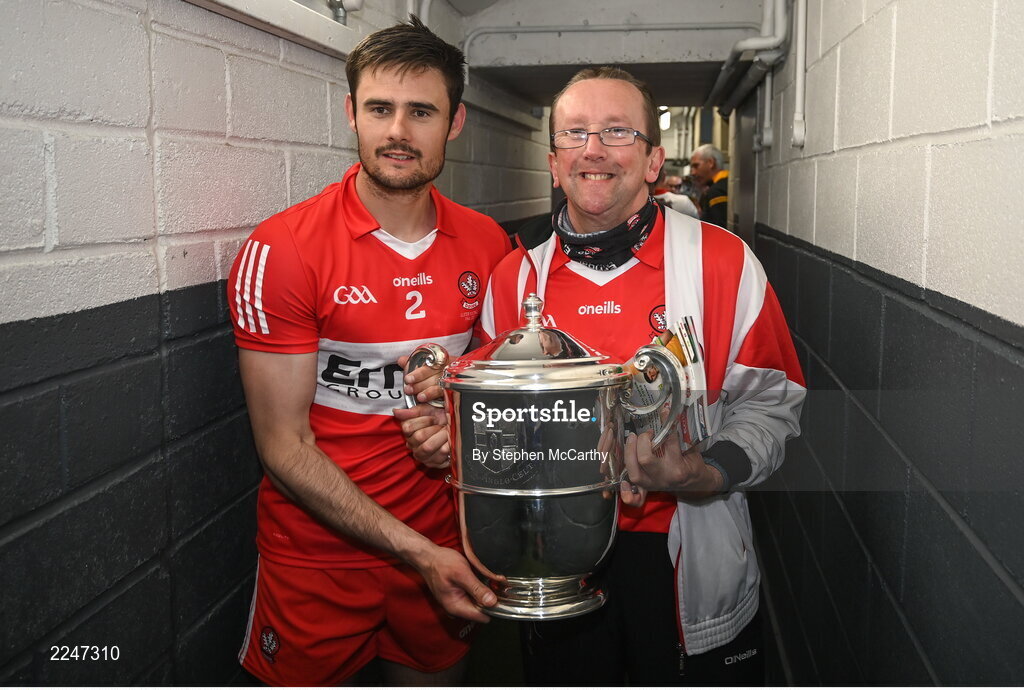 29 May 2022; Christopher McKaigue of Derry and a supporter bring the Anglo Celt Cup to the dressing room after the Ulster GAA Football Senior Championship Final between Derry and Donegal at St Tiernach's Park in Clones, Monaghan. Photo by Stephen McCarthy/Sportsfile
