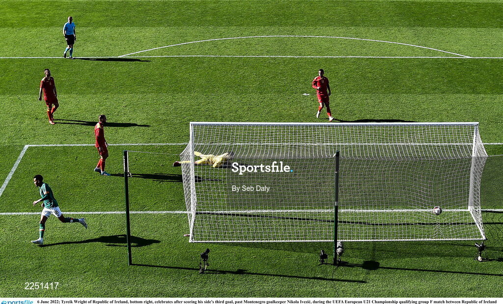 6 June 2022; Tyreik Wright of Republic of Ireland, bottom right, celebrates after scoring his side's third goal, past Montenegro goalkeeper Nikola Ivezic, during the UEFA European U21 Championship qualifying group F match between Republic of Ireland and Montenegro at Tallaght Stadium in Dublin. Photo by Seb Daly/Sportsfile