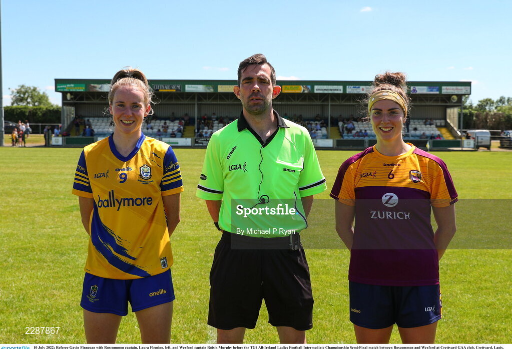 10 July 2022; Referee Gavin Finnegan with Roscommon captain, Laura Fleming, left, and Wexford captain Róisín Murphy before the TG4 All-Ireland Ladies Football Intermediate Championship Semi-Final match between Roscommon and Wexford at Crettyard GAA club, Crettyard, Laois. Photo by Michael P Ryan/Sportsfile