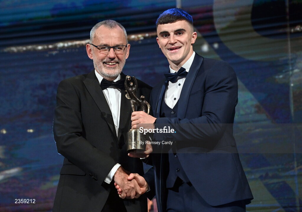 28 October 2022; Sean O’Shea of Kerry is presented with his PwC All-Star award by Uachtarán Chumann Lúthchleas Gael Larry McCarthy during the PwC All-Stars Awards 2022 show at the Convention Centre in Dublin. Photo by Ramsey Cardy/Sportsfile