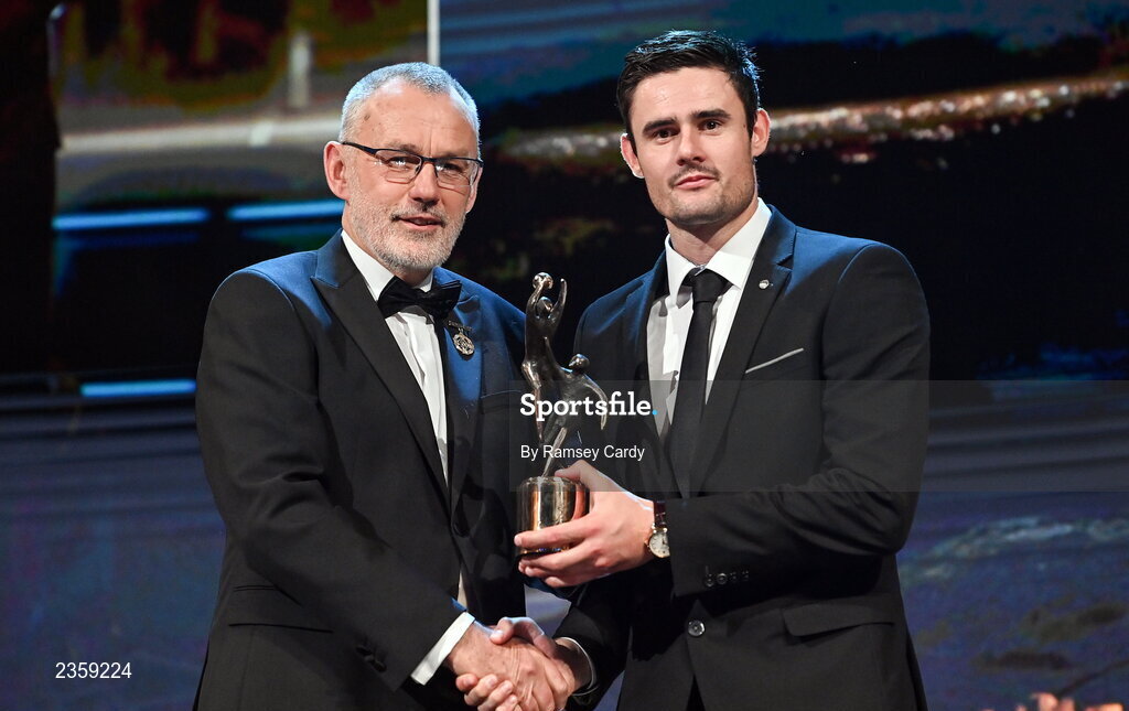 28 October 2022; Chrissy McKaigue of Derry is presented with his PwC All-Star award by Uachtarán Chumann Lúthchleas Gael Larry McCarthy during the PwC All-Stars Awards 2022 show at the Convention Centre in Dublin. Photo by Ramsey Cardy/Sportsfile