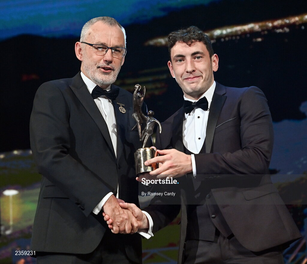 28 October 2022; Paudie Clifford of Kerry is presented with his PwC All-Star award by Uachtarán Chumann Lúthchleas Gael Larry McCarthy during the PwC All-Stars Awards 2022 show at the Convention Centre in Dublin. Photo by Ramsey Cardy/Sportsfile