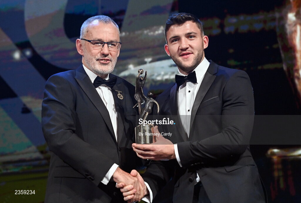 28 October 2022; Damien Comer of Galway is presented with his PwC All-Star award by Uachtarán Chumann Lúthchleas Gael Larry McCarthy during the PwC All-Stars Awards 2022 show at the Convention Centre in Dublin. Photo by Ramsey Cardy/Sportsfile