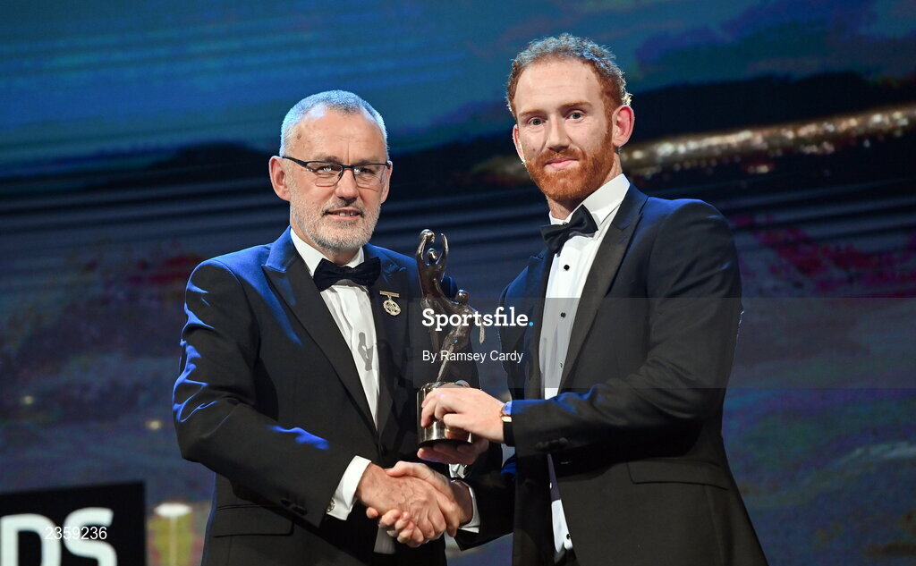 28 October 2022; Conor Glass of Derry is presented with his PwC All-Star award by Uachtarán Chumann Lúthchleas Gael Larry McCarthy during the PwC All-Stars Awards 2022 show at the Convention Centre in Dublin. Photo by Ramsey Cardy/Sportsfile