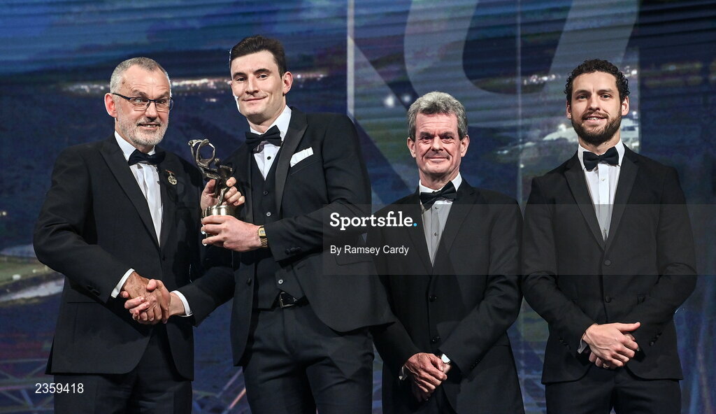 28 October 2022; David Fitzgerald of Clare is presented with his PwC All-Star award by Uachtarán Chumann Lúthchleas Gael Larry McCarthy, PwC Ireland managing partner Feargal O'Rourke and GPA chief executive officer Tom Parsons during the PwC All-Stars Awards 2022 show at the Convention Centre in Dublin. Photo by Ramsey Cardy/Sportsfile
